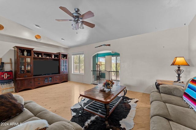 living room featuring light hardwood / wood-style flooring, vaulted ceiling, and ceiling fan