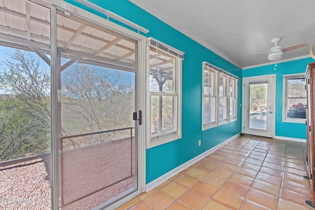 entryway with crown molding, ceiling fan, and light tile patterned floors