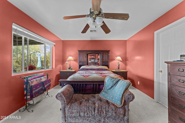 bedroom featuring light colored carpet and ceiling fan