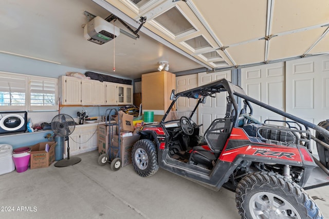 garage featuring a garage door opener and washer / clothes dryer