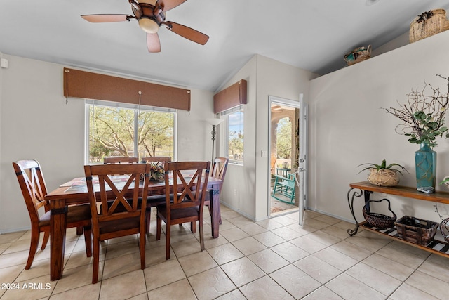 dining room with vaulted ceiling, ceiling fan, and light tile patterned floors