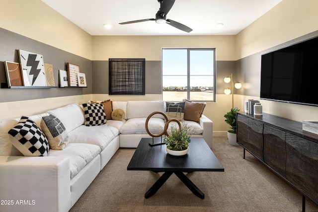 living room with a ceiling fan and light colored carpet