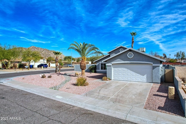 ranch-style home with a garage and a mountain view