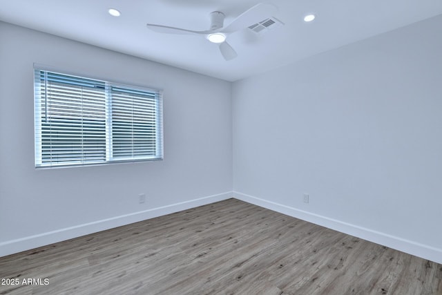 spare room with light hardwood / wood-style flooring and ceiling fan