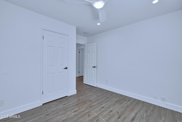 unfurnished room with ceiling fan and light hardwood / wood-style floors