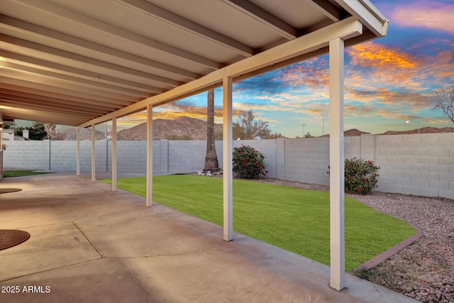 patio terrace at dusk with a lawn