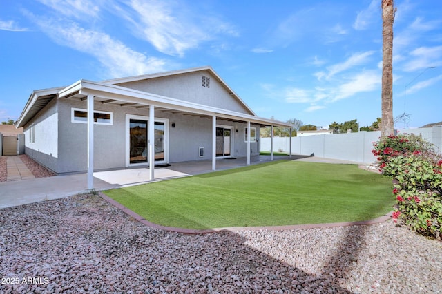 back of house with a yard and a patio area