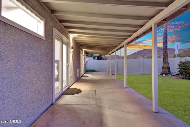 patio terrace at dusk with a lawn