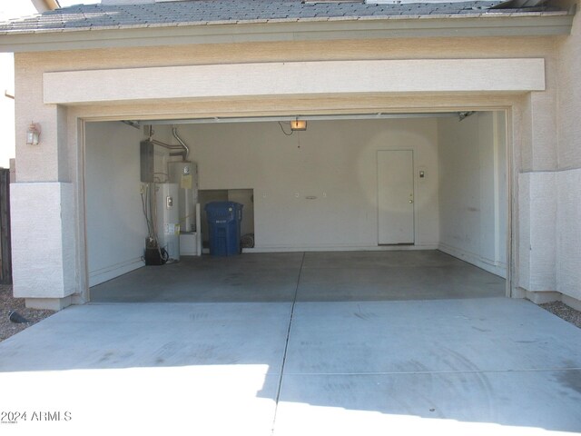 garage with electric water heater and water heater