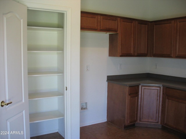 kitchen with dark tile patterned flooring