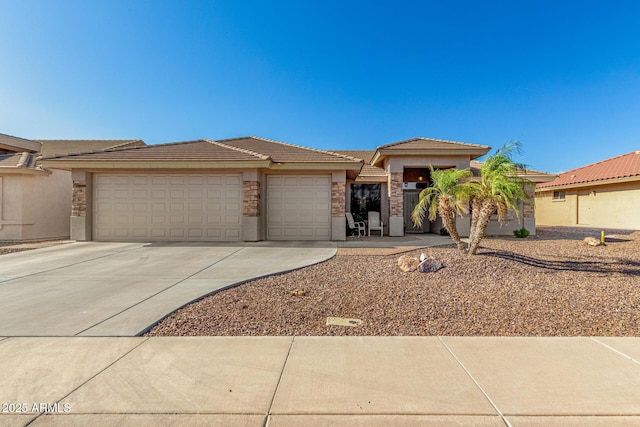 11312 E Newcastle Ave, Mesa, AZ 85209 - prairie-style house with a garage, concrete driveway, stucco siding, and a tile roof