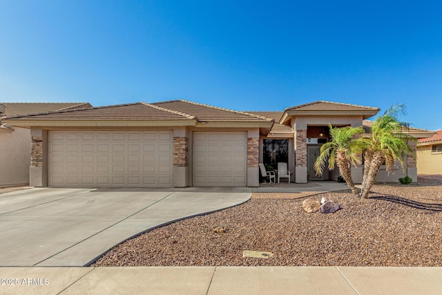 11312 E Newcastle Ave, Mesa, AZ 85209 - prairie-style home with driveway, an attached garage, stucco siding, and a tiled roof