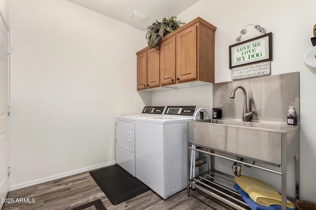 11312 E Newcastle Ave, Mesa, AZ 85209 - laundry area featuring separate washer and dryer, dark wood-style flooring, and cabinet space