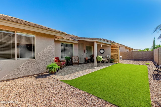 11312 E Newcastle Ave, Mesa, AZ 85209 - rear view of property featuring stucco siding, a fenced backyard, and a patio
