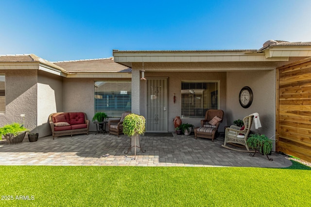 11312 E Newcastle Ave, Mesa, AZ 85209 - property entrance featuring stucco siding, a patio, a yard, an outdoor living space, and a tiled roof