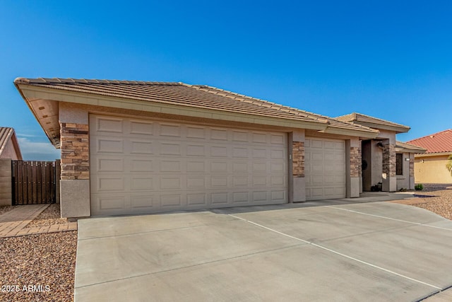 11312 E Newcastle Ave, Mesa, AZ 85209 - view of front of property featuring stone siding, an attached garage, concrete driveway, and a tile roof