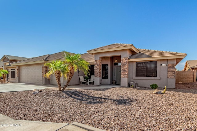 11312 E Newcastle Ave, Mesa, AZ 85209 - prairie-style home featuring a garage, stucco siding, concrete driveway, a tile roof, and stone siding