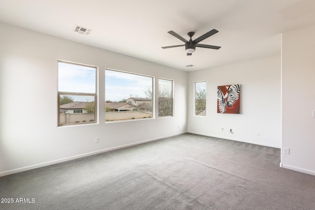 unfurnished room featuring ceiling fan and carpet