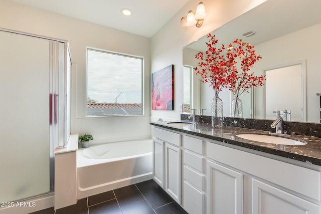 bathroom with vanity, tile patterned floors, and plus walk in shower