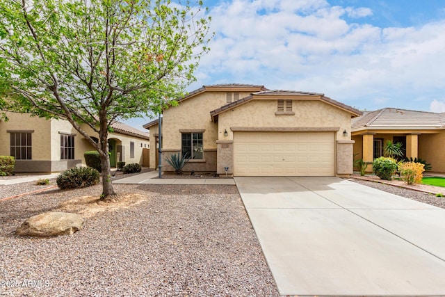 view of front of home featuring stucco siding, a tiled roof, concrete driveway, and a garage