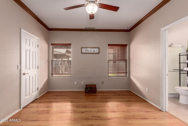 unfurnished bedroom featuring visible vents, ensuite bathroom, light wood-style flooring, and crown molding