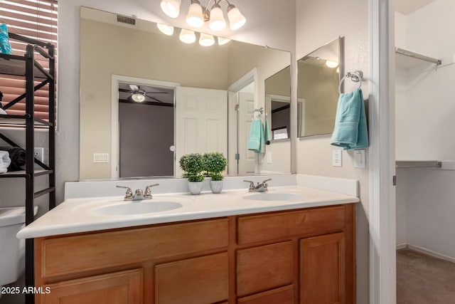 bathroom with a sink, visible vents, and double vanity