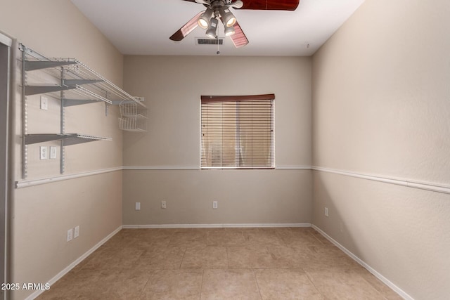 unfurnished room with tile patterned floors, baseboards, visible vents, and ceiling fan