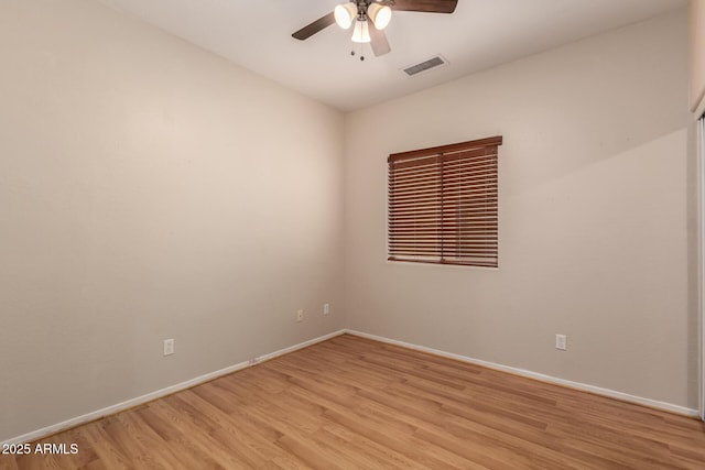 empty room with visible vents, baseboards, light wood-style flooring, and a ceiling fan