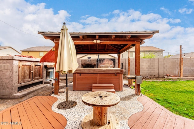 wooden terrace featuring a yard, fence, area for grilling, and a hot tub