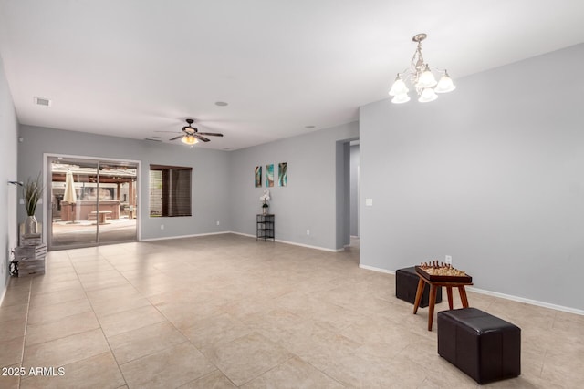 unfurnished living room featuring ceiling fan with notable chandelier, light tile patterned floors, baseboards, and visible vents