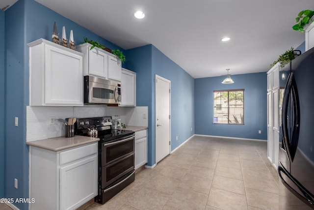 kitchen featuring light countertops, white cabinets, backsplash, and stainless steel appliances