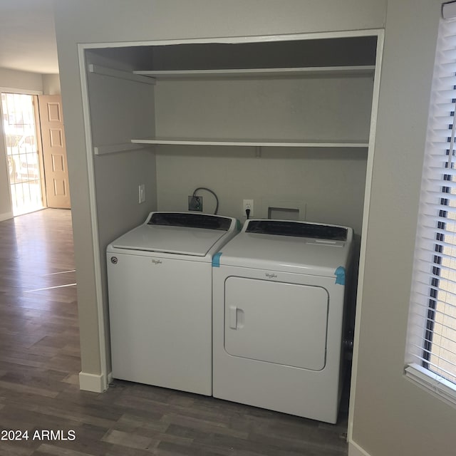 clothes washing area featuring washer and clothes dryer and dark hardwood / wood-style floors