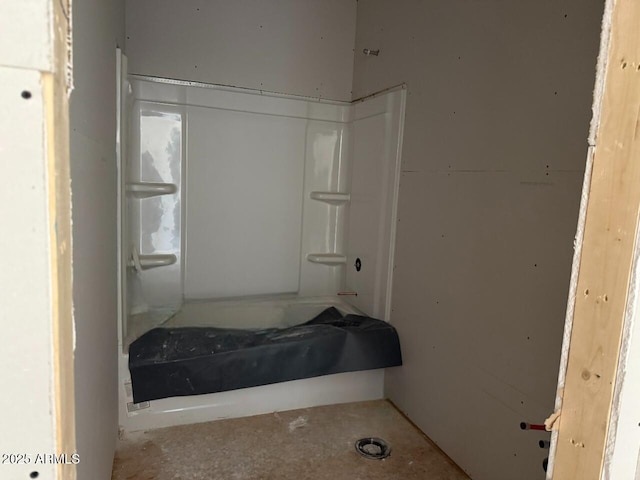 bathroom with walk in shower and unfinished concrete floors