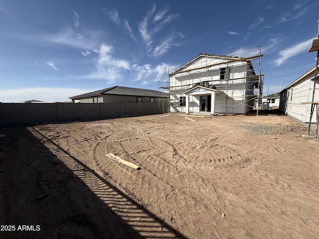 back of house with fence