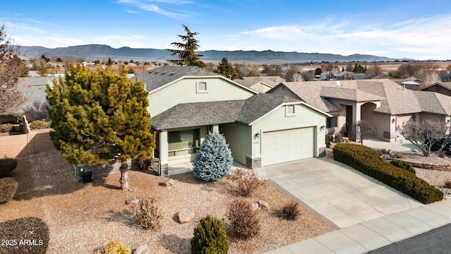 ranch-style home with a mountain view and a garage