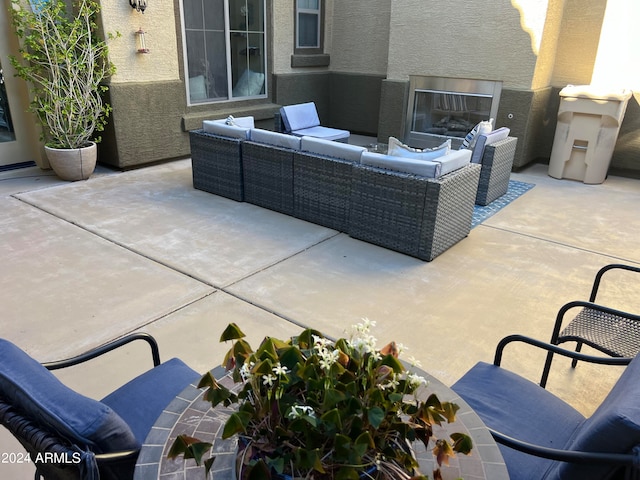 view of patio / terrace with an outdoor living space with a fireplace