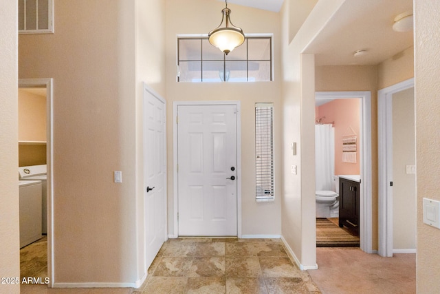 300 W Cardinal Way, Chandler, AZ 85286 - foyer entrance featuring washer / dryer, baseboards, and a towering ceiling