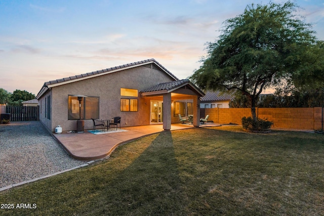 300 W Cardinal Way, Chandler, AZ 85286 - back of property at dusk featuring a tile roof, a patio, and stucco siding