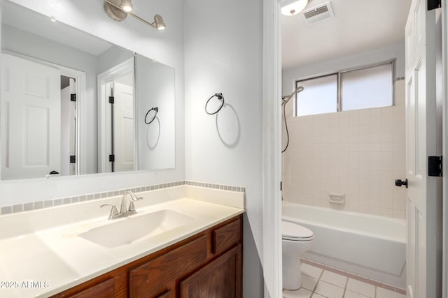 full bathroom with vanity, toilet, tiled shower / bath combo, and tile patterned flooring