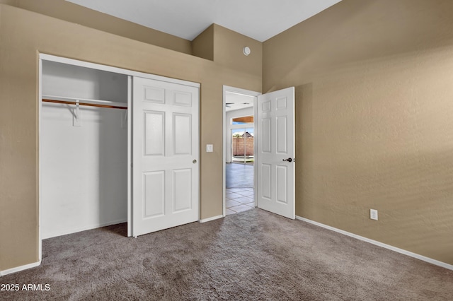 unfurnished bedroom with a closet, baseboards, and carpet