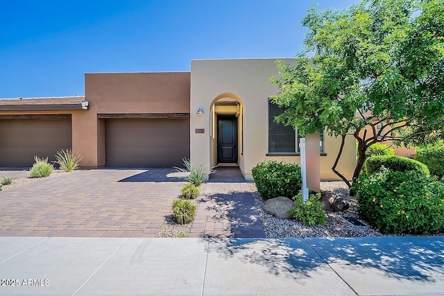 pueblo-style home featuring a garage