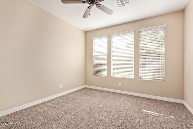 spare room featuring carpet floors and ceiling fan