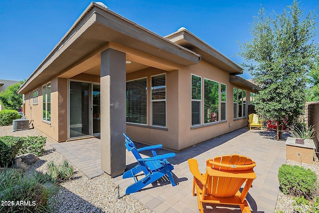 rear view of property featuring a patio and central AC unit