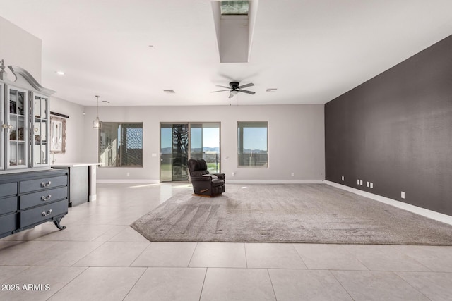 unfurnished living room with ceiling fan and light tile patterned floors