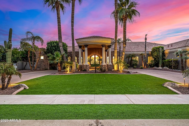 mediterranean / spanish house with a lawn