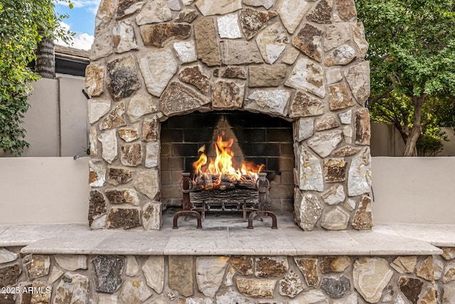 exterior details featuring an outdoor stone fireplace