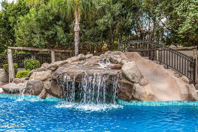 view of pool featuring pool water feature