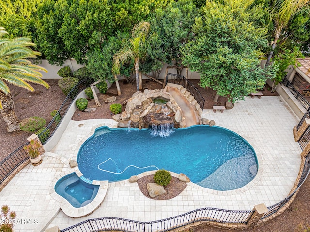 view of swimming pool with an in ground hot tub and a patio area