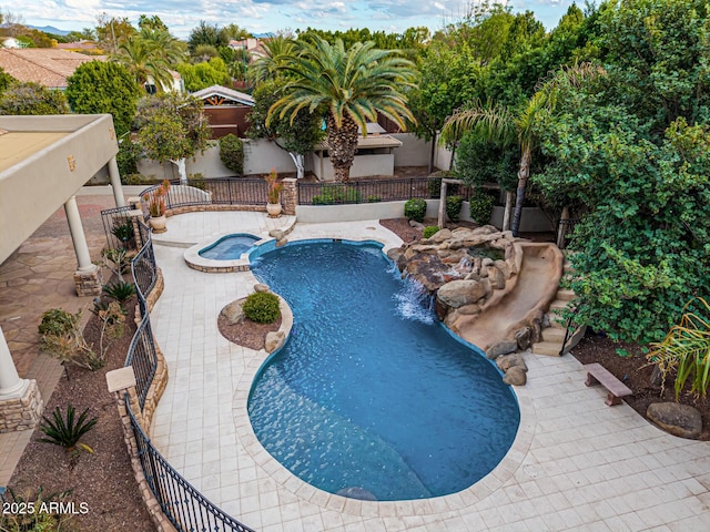 view of swimming pool with an in ground hot tub and a patio