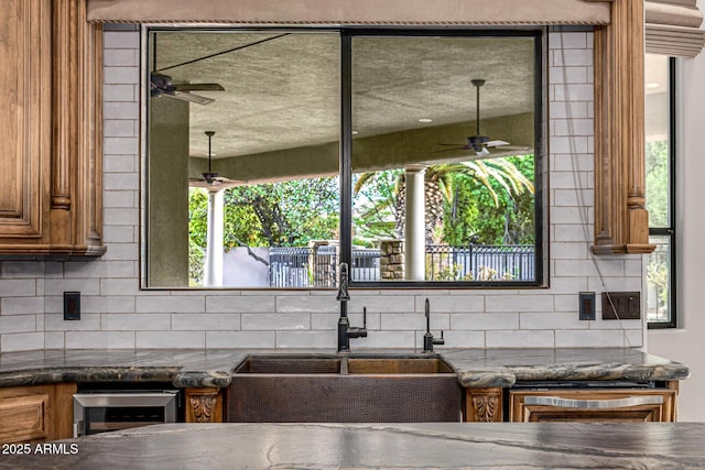 kitchen with tasteful backsplash, wine cooler, and sink